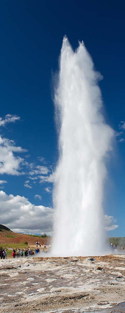 Impressive eruption of the biggest active geysir, Strokkur, with tourists waiting around, Golden circle, Iceland